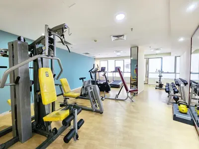 a gym with treadmills and machines in a room at RH- Convenient 1BR, Central, Walk to Mall of Emirates, Al Barsha1 in Dubai