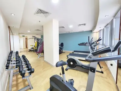 a gym with treadmills and ellipticals in a room at RH- Convenient 1BR, Central, Walk to Mall of Emirates, Al Barsha1 in Dubai