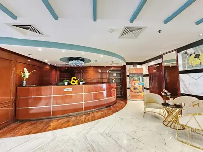 a lobby with a reception desk and chairs at RH- Convenient 1BR, Central, Walk to Mall of Emirates, Al Barsha1 in Dubai