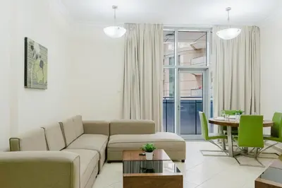 a living room with a couch and a table at RH- Modern Urban Oasis, Spacious 02RB near mall of Emirates in Dubai