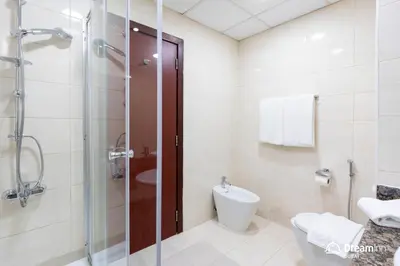 a bathroom with a shower and a toilet and a sink at Dream Inn Apartments - Rimal JBR in Dubai