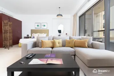 a living room with a couch and a table at Dream Inn Apartments - Rimal JBR in Dubai