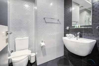 a bathroom with a white toilet and a sink at Captivating Studio at Giovanni Boutique Suites DSC by Deluxe Holiday Homes in Dubai