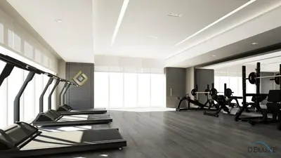 a gym with treadmills and machines in a room at Captivating Studio at Giovanni Boutique Suites DSC by Deluxe Holiday Homes in Dubai