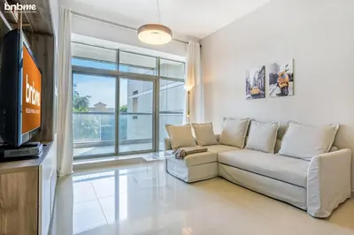 a living room with a couch and a tv at bnbmehomes - The Medalist in Dubai