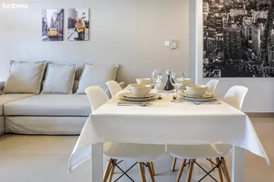 a white table with white chairs and a white couch at bnbmehomes - The Medalist in Dubai