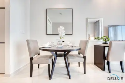 a dining room with a black table and chairs at Restful Studio at Celestia A Dubai South by Deluxe Holiday Homes in Dubai