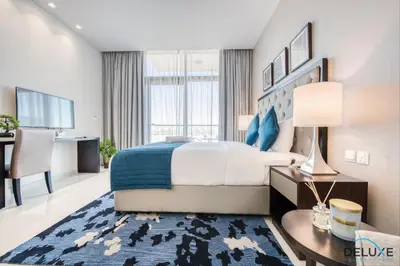 a hotel room with a bed and a desk at Restful Studio at Celestia A Dubai South by Deluxe Holiday Homes in Dubai