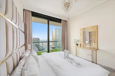 a white bedroom with a bed and a large window at Luxury 2BR Skyline Sea View Direct Mall Metro Dining Shops City Walk in Dubai