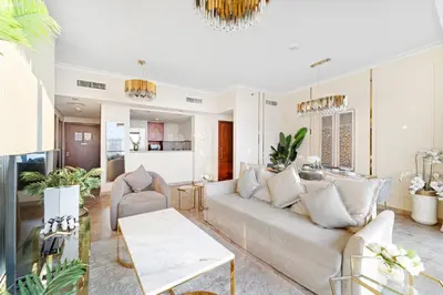 a living room with a couch and a table at Luxury 2BR Skyline Sea View Direct Mall Metro Dining Shops City Walk in Dubai