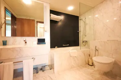 a bathroom with a toilet and a shower and a sink at Emaar Fashion Avenue one bedroom - Formerly Address Dubai Mall Four Apple Holiday Homes in Dubai