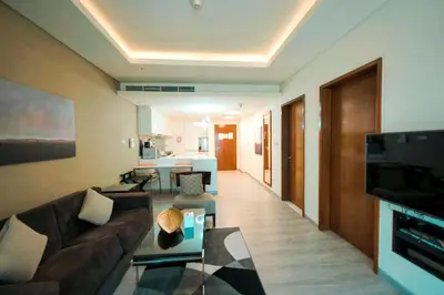a living room with a couch and a table at Emaar Fashion Avenue one bedroom - Formerly Address Dubai Mall Four Apple Holiday Homes in Dubai