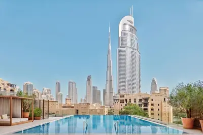 a swimming pool with a view of a city skyline at The Dubai EDITION in Dubai