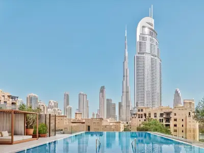 a swimming pool with a view of a city skyline at The Dubai EDITION in Dubai