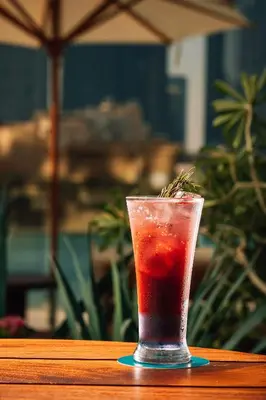 a drink in a glass sitting on a table at The Dubai EDITION in Dubai