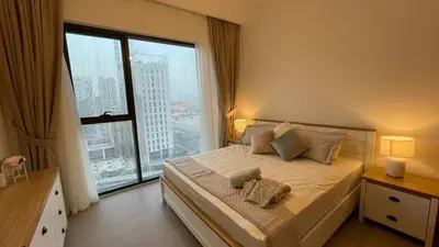 a bedroom with a bed with a large window at Elite Inn: Parkridge904 in Dubai