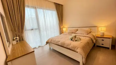 a bedroom with a bed and a large window at Elite Inn: Parkridge904 in Dubai