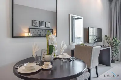 a dining room with a table and chairs at Immaculate Studio at DAMAC Celestia by Deluxe Holiday Homes in Dubai