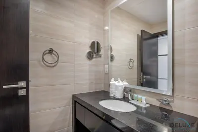 a bathroom with a sink and a mirror at Immaculate Studio at DAMAC Celestia by Deluxe Holiday Homes in Dubai