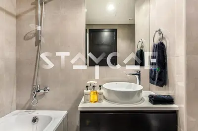 a bathroom with a sink and a shower and a tub at Staycae Holiday Homes - Merano in Dubai