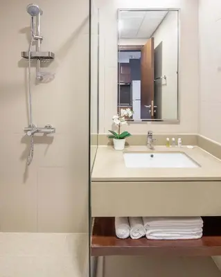 a bathroom with a sink and a shower at Silkhaus renovated studio with Burj Khalifa view in DIFC in Dubai