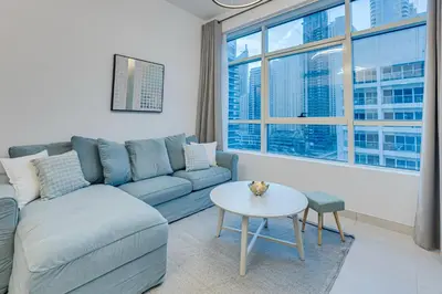 a living room with a couch and a table at Great views from New apartment in Dubai Marina in Dubai