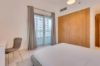 a bedroom with a bed and a large window at Great views from New apartment in Dubai Marina in Dubai