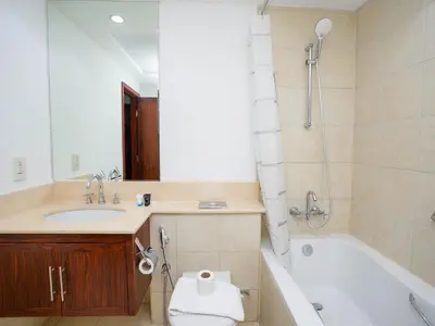 a bathroom with a sink and a tub and a toilet at Holidays R Us villa 3 bedroom premium location in Dubai