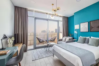 a hotel room with a large bed and a large window at Silkhaus elegant studio with Burj Khalifa view and balcony in Dubai
