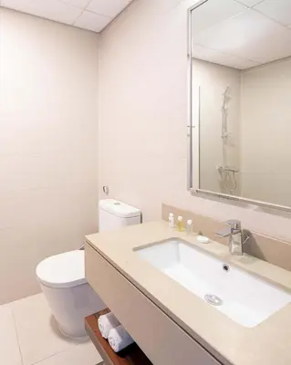 a bathroom with a sink and a toilet at Silkhaus modern furnished studio in DIFC center with balcony in Dubai