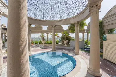 a swimming pool in a building with a domed ceiling at HiGuests - Luxury Apartment in the Iconic Park Towers in Dubai