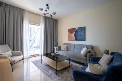 a living room with a couch and a table at HiGuests - Luxury Apartment in the Iconic Park Towers in Dubai