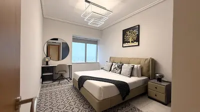 a bedroom with a bed and a mirror at Trinity Holiday Homes - Sheikh Zayed Road Right Next to Financial Center Metro Station Exit 1 in Dubai