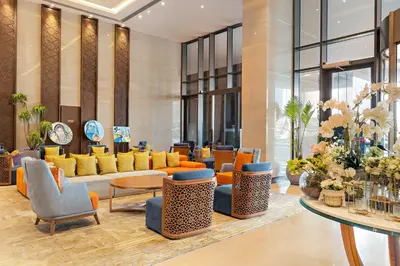a lobby with couches and chairs and tables at Ramee Dream Hotel Downtown in Dubai