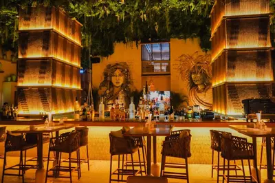 a bar in a restaurant with tables and chairs at Ramee Dream Hotel Downtown in Dubai
