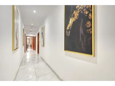 a hallway with paintings on the walls of a building at THE PENTHOUSE near Burj Khalifa and Dubai Mall in Dubai