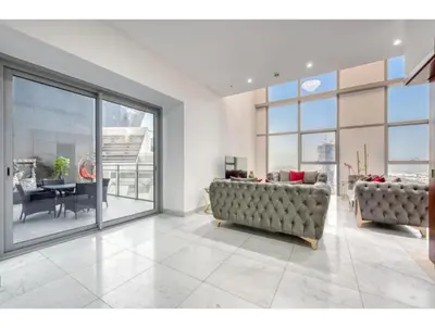 a living room with two couches and a table at THE PENTHOUSE near Burj Khalifa and Dubai Mall in Dubai
