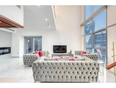 a large living room with couches and a fireplace at THE PENTHOUSE near Burj Khalifa and Dubai Mall in Dubai