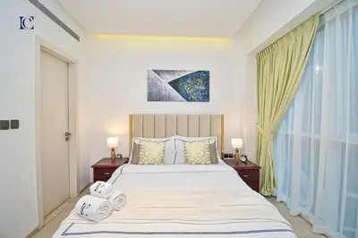 a bedroom with a large bed with two night stands at Luxury Escapes - 1BR Apt with Balcony - West Avenue Marina in Dubai