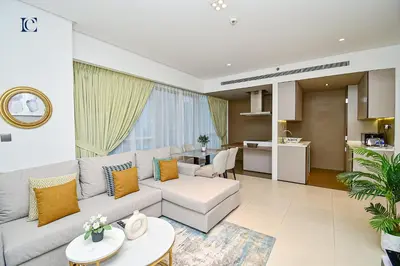 a living room with a couch and a table at Luxury Escapes - 1BR Apt with Balcony - West Avenue Marina in Dubai
