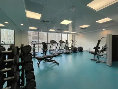 a gym with a bunch of treadms and machines at GuestReady - The Wandering Oasis in Town Square in Dubai