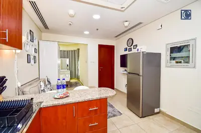 a kitchen with a refrigerator and a counter at Luxury Escapes - Budget Studio - New Dubai Gate 2 JLT in Dubai