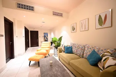 a living room with a couch and some chairs at Newly furnished. Cozy apartment. Quite location. in Dubai