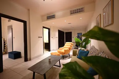 a living room with a couch and chairs and a table at Newly furnished. Cozy apartment. Quite location. in Dubai