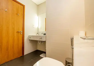 a bathroom with a toilet and a sink at Hometown Apartments - Cosy 1 Br Apartment with Brand New Furniture in DIFC in Dubai