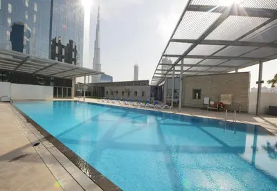 a large swimming pool on top of a building at Hometown Apartments - Cosy 1 Br Apartment with Brand New Furniture in DIFC in Dubai