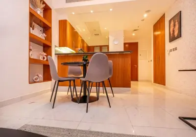a kitchen with chairs and a table in a room at Hometown Apartments - Cosy 1 Br Apartment with Brand New Furniture in DIFC in Dubai