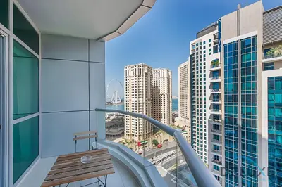 a balcony with a wooden bench on a building at Full Marina and Ain Dubai Wheel View 1BR at The Point Dubai Marina by Deluxe Holiday Homes in Dubai