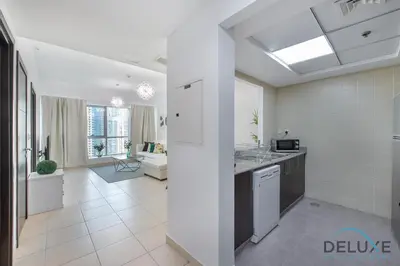 a kitchen and living room with a counter top at Full Marina and Ain Dubai Wheel View 1BR at The Point Dubai Marina by Deluxe Holiday Homes in Dubai