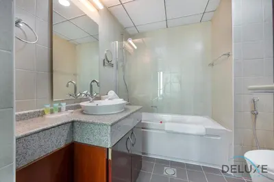 a bathroom with a sink and a bath tub at Full Marina and Ain Dubai Wheel View 1BR at The Point Dubai Marina by Deluxe Holiday Homes in Dubai